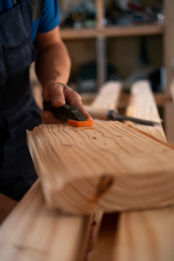 male-wood-worker-his-shop-working-with-tools-equipment_600x900